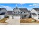 Two-story home with a covered front porch, a three car garage and coordinated landscaping at 526 Carroll St, New Whiteland, IN 46184