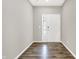 Welcoming foyer featuring stylish wood-look flooring and a bright white front door with sidelight at 526 Carroll St, New Whiteland, IN 46184