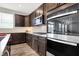 Modern kitchen with stainless steel appliances and dark wood cabinets at 526 Carroll St, New Whiteland, IN 46184