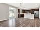 Modern kitchen featuring stainless steel appliances, a central island, and sliding glass doors to the yard at 526 Carroll St, New Whiteland, IN 46184