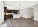 Open-concept kitchen with stainless steel appliances, a central island, and hardwood floors at 526 Carroll St, New Whiteland, IN 46184