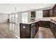 Kitchen featuring stainless steel dishwasher, sink, and hardwood flooring with an open concept to the living room at 526 Carroll St, New Whiteland, IN 46184