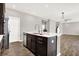 Kitchen island featuring stainless steel dishwasher, sink, and hardwood flooring with an open concept at 526 Carroll St, New Whiteland, IN 46184
