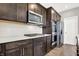 Kitchen with stainless steel appliances, white backsplash, and dark wood cabinets at 526 Carroll St, New Whiteland, IN 46184