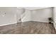 Inviting living area featuring wood-look floors, neutral paint, and a staircase to the upper level at 526 Carroll St, New Whiteland, IN 46184