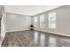 Spacious living room showcasing wood-look floors, recessed lighting, and bright, sunny windows at 526 Carroll St, New Whiteland, IN 46184