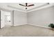Spacious main bedroom with a tray ceiling, neutral carpet and a modern ceiling fan at 526 Carroll St, New Whiteland, IN 46184