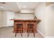 Basement bar area with two stools and custom wooden cabinets at 538 Cyclamen Chase, Westfield, IN 46074