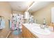 Well-lit bathroom with a double sink vanity and colorful shower curtain at 538 Cyclamen Chase, Westfield, IN 46074