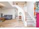 Bright foyer featuring hardwood floors, a staircase with white railings, and views into the living spaces at 538 Cyclamen Chase, Westfield, IN 46074