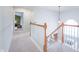 Upstairs hallway with wooden banister and a view of the entry foyer below at 538 Cyclamen Chase, Westfield, IN 46074