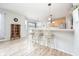 Bright kitchen features a breakfast bar with seating, stainless steel appliances and stylish pendant lighting at 538 Cyclamen Chase, Westfield, IN 46074