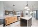 Kitchen with stainless steel appliances and breakfast bar open to living room with fireplace at 538 Cyclamen Chase, Westfield, IN 46074