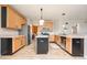 Kitchen featuring stainless steel appliances, wooden cabinets, and an island with space for seating at 538 Cyclamen Chase, Westfield, IN 46074