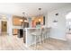 Eat-in kitchen featuring wooden cabinets, stainless steel appliances, and a stylish breakfast bar at 538 Cyclamen Chase, Westfield, IN 46074