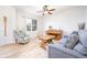Cozy living room with hardwood floors, light gray couch, piano, and a ceiling fan at 538 Cyclamen Chase, Westfield, IN 46074