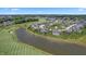 Aerial view of home in community near lake and golf course with lush greenery and well-maintained landscaping at 565 Old Ashbury Rd, Westfield, IN 46074