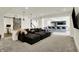 Spacious basement with open-concept living area, featuring a large sectional sofa, bar, and barn door at 565 Old Ashbury Rd, Westfield, IN 46074