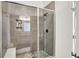 Modern bathroom featuring a tiled walk-in shower with a glass door and a matte black shower head at 565 Old Ashbury Rd, Westfield, IN 46074