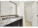 Bathroom featuring a granite countertop, modern fixtures, and a doorway that leads to a toilet and shower area at 565 Old Ashbury Rd, Westfield, IN 46074