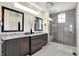 Elegant bathroom featuring dual sinks, a marble countertop, and a frameless glass shower at 565 Old Ashbury Rd, Westfield, IN 46074