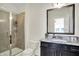 Well-lit bathroom showcasing a glass-enclosed shower and a vanity with a granite countertop at 565 Old Ashbury Rd, Westfield, IN 46074