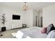 Bright bedroom with a flat screen tv, stylish decor, and modern lighting at 565 Old Ashbury Rd, Westfield, IN 46074