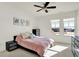 Bright bedroom with a ceiling fan, neutral color scheme, and natural light from two large windows at 565 Old Ashbury Rd, Westfield, IN 46074
