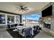Relaxing covered patio with an outdoor fireplace, comfortable seating, and scenic backyard views at 565 Old Ashbury Rd, Westfield, IN 46074