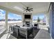 Outdoor living space with a stone fireplace, comfortable seating, and views of the surrounding neighborhood at 565 Old Ashbury Rd, Westfield, IN 46074