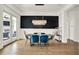 Elegant dining room with a modern chandelier, bold accent wall, and stylish blue upholstered chairs at 565 Old Ashbury Rd, Westfield, IN 46074