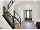 Beautiful foyer with hardwood floors, modern staircase, and stylish front door at 565 Old Ashbury Rd, Westfield, IN 46074