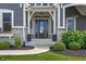 Inviting front entry featuring a stylish front door, stone accents, and manicured landscaping at 565 Old Ashbury Rd, Westfield, IN 46074