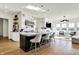 Well-lit kitchen boasts stainless steel appliances, island with seating, and an open layout for easy entertaining at 565 Old Ashbury Rd, Westfield, IN 46074