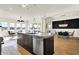 Large kitchen island with seating that overlooks the living area and fireplace at 565 Old Ashbury Rd, Westfield, IN 46074
