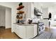 This lovely kitchen space has stainless steel appliances, modern cabinets, and a fireplace at 565 Old Ashbury Rd, Westfield, IN 46074