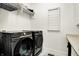 Bright laundry room with front-loading Samsung washer and dryer and convenient shelving at 565 Old Ashbury Rd, Westfield, IN 46074