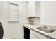 Practical laundry room with ample counter space, a sink, and built-in storage cabinets at 565 Old Ashbury Rd, Westfield, IN 46074