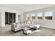 Bright and airy living room featuring a comfortable gray sofa, natural light, and modern wine storage at 565 Old Ashbury Rd, Westfield, IN 46074
