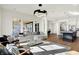 Spacious living room featuring a modern chandelier, large windows, and open floor plan at 565 Old Ashbury Rd, Westfield, IN 46074