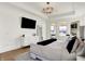 Well-lit main bedroom with a large dresser, flat screen tv and private balcony at 565 Old Ashbury Rd, Westfield, IN 46074
