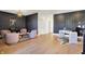 Open office space with a seating area, textured wallpaper, hardwood floors, and modern decor at 565 Old Ashbury Rd, Westfield, IN 46074