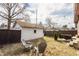 Backyard with a well-maintained lawn, mature trees, a shed, and an outdoor seating area at 6189 Primrose Ave, Indianapolis, IN 46220