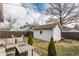 Backyard view features an outdoor seating area with a gas firepit, a shed, and mature trees at 6189 Primrose Ave, Indianapolis, IN 46220