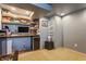 Finished basement area featuring neutral carpet and decor and built-in shelves stocked with games at 6189 Primrose Ave, Indianapolis, IN 46220