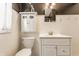 Clean bathroom featuring a toilet, sink, and white cabinetry at 6189 Primrose Ave, Indianapolis, IN 46220