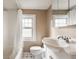 Cozy bathroom featuring a shower/tub combo, white vanity, and large window at 6189 Primrose Ave, Indianapolis, IN 46220