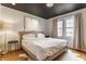 Comfortable bedroom featuring a large window, neutral colors, and lots of pillows at 6189 Primrose Ave, Indianapolis, IN 46220