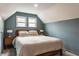 Bedroom with a pitched ceiling, natural light, and simple decor at 6189 Primrose Ave, Indianapolis, IN 46220