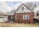 A delightful brick home boasting a charming porch and Tudor-style architectural details at 6189 Primrose Ave, Indianapolis, IN 46220